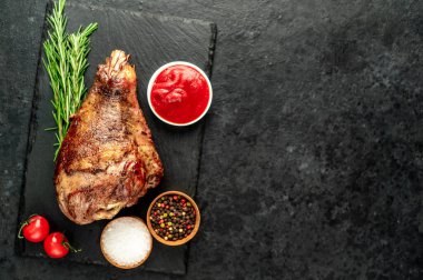 Izgara hindi budu ve siyah arka planda sebze ve baharatlar.