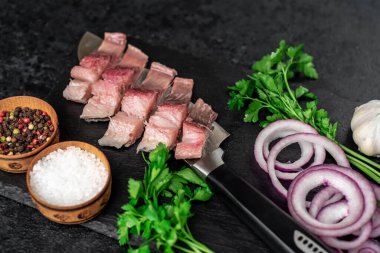 Tahtada soğan, baharat ve otlu çiğ balık parçaları..