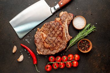 Baharatlı ızgara biftek ve siyah arka planda biberiye.