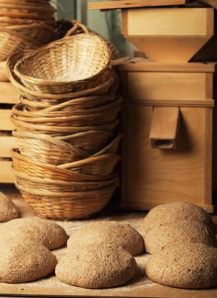 Basket with bread dough and a small mill — Stock Photo, Image