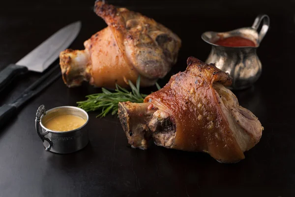 Roasted pork knuckle with mustard, spices and rosemary — Stock Photo, Image