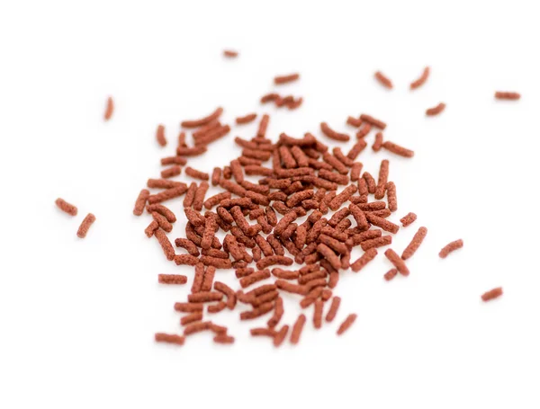 Isolated close-up of bloodworm fish food pellets — Stock Photo, Image