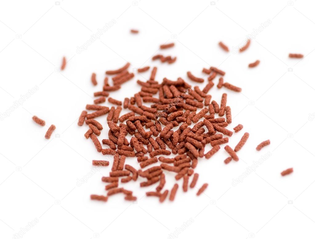 Isolated close-up of bloodworm fish food pellets