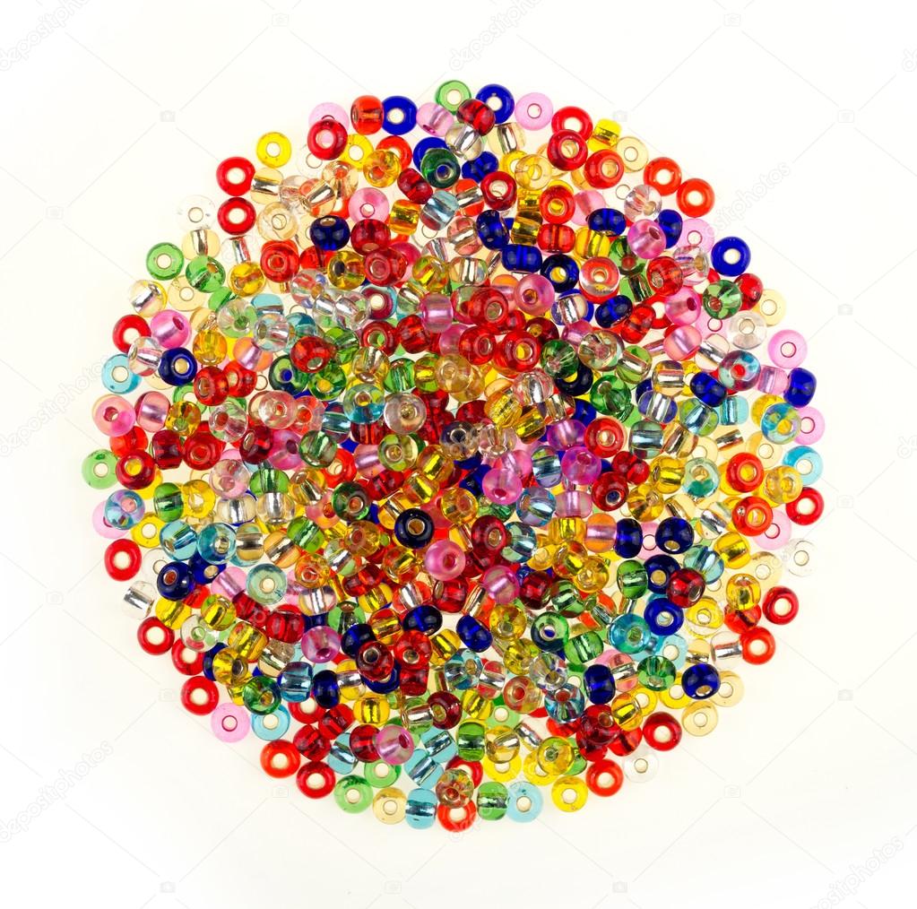 Pile of colorful glass beads isolated on white background
