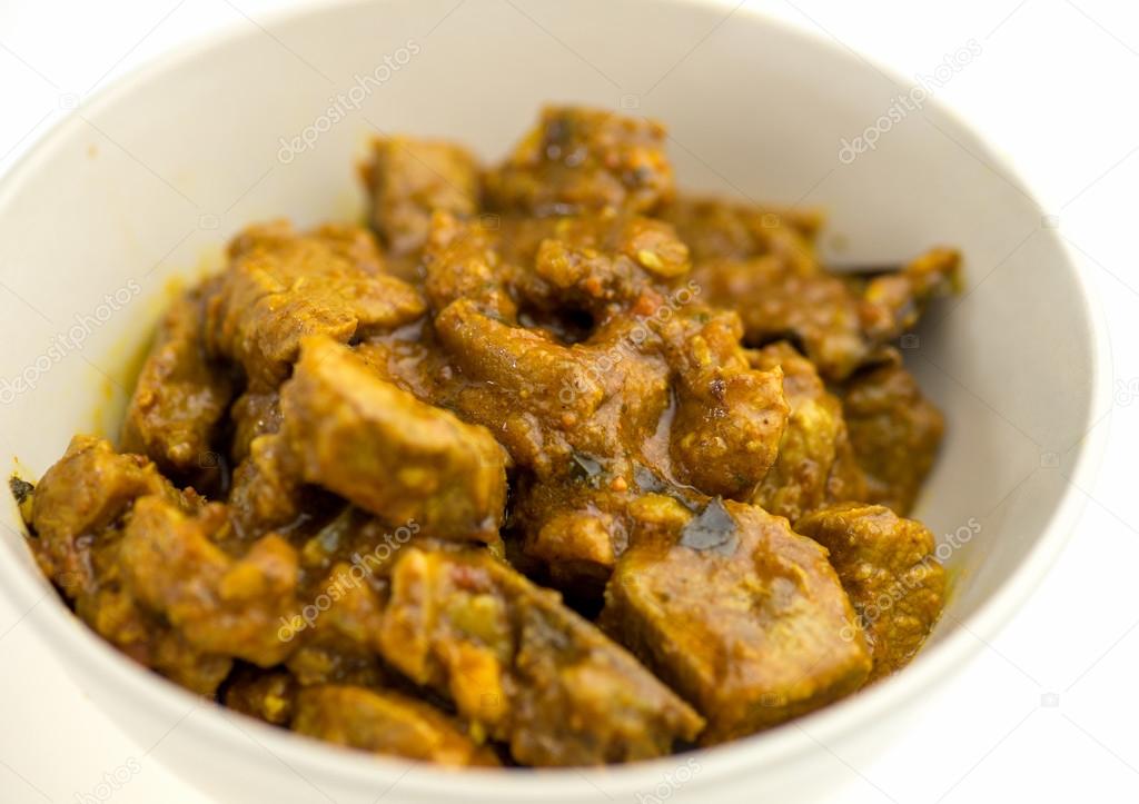 Tasty Indian lamb curry against white