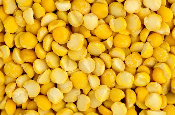 Macro closeup background texture of yellow chana split peas — Stock Photo, Image