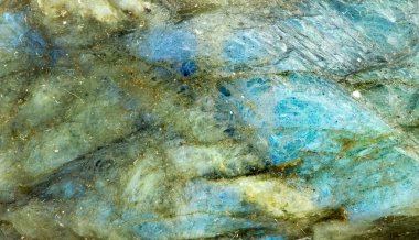 Macro background texture closeup of glowing blue labradorite gem clipart