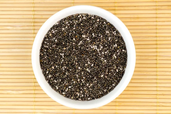 Aerial closeup of chia seeds on bamboo mat — Stock Photo, Image