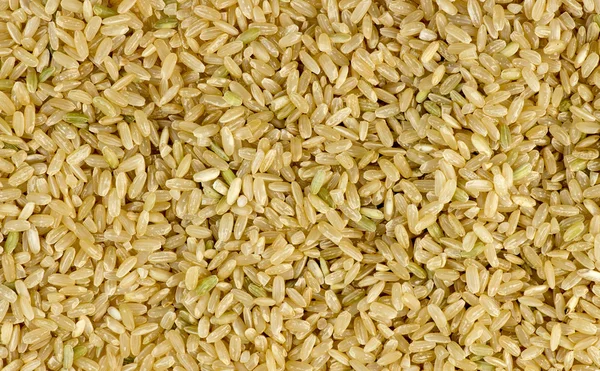 Overhead macro shot of uncooked raw brown rice background textur — Stock Photo, Image