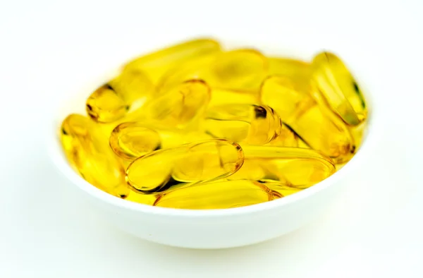 Closeup of yellow omega-3 fish oil capsules — Stock Photo, Image