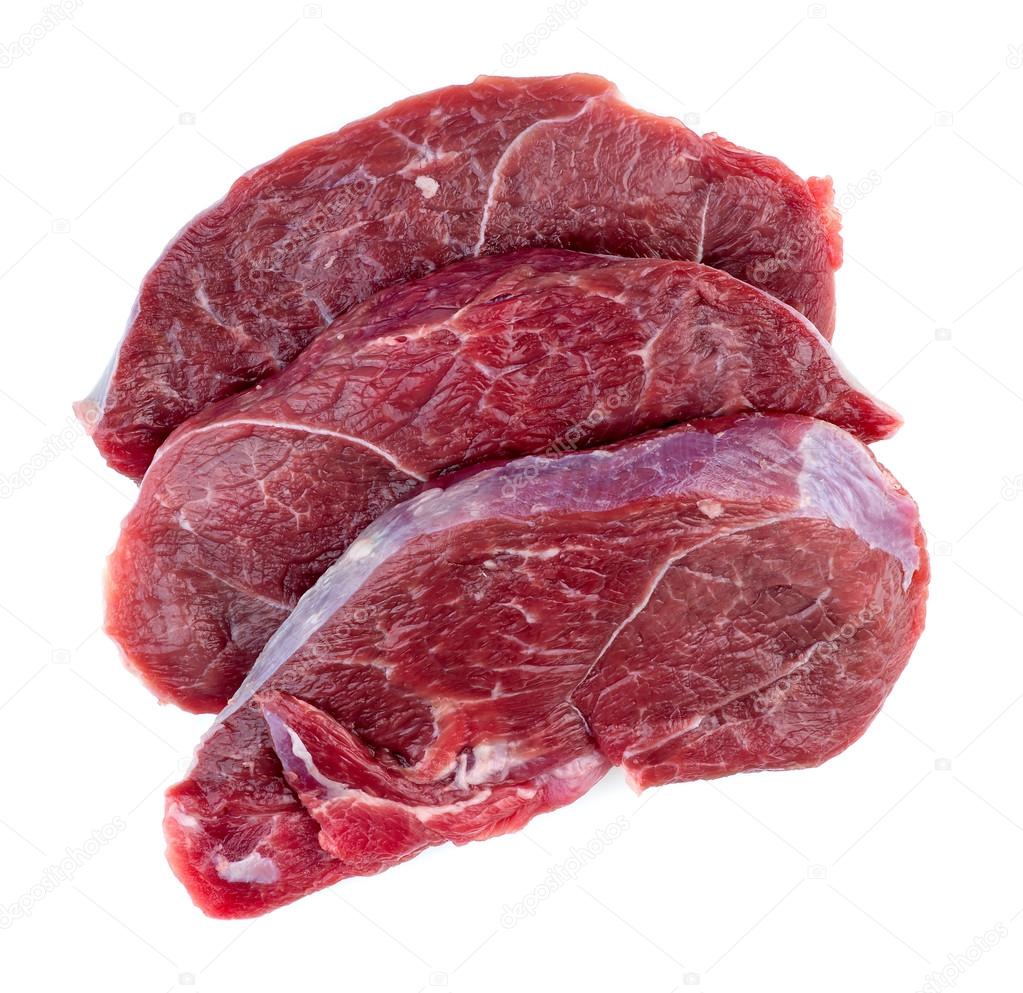 Aerial of raw red meat steaks isolated against a white backgroun