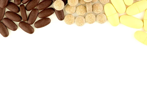 Multi colored pills scattered on white background with aerial vi — Stock Photo, Image