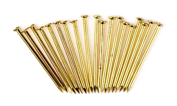 Row of new golden brass nails isolated on white — Stock Photo, Image