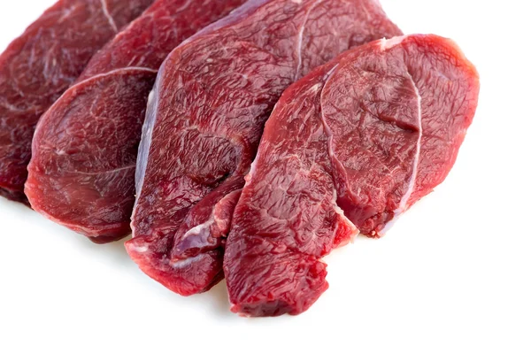 Studio shot of raw red meat steaks isolated against a white back — Stock Photo, Image