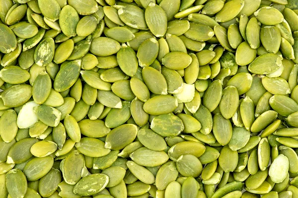 Macro background texture of green pumpkin seeds — Stock Photo, Image