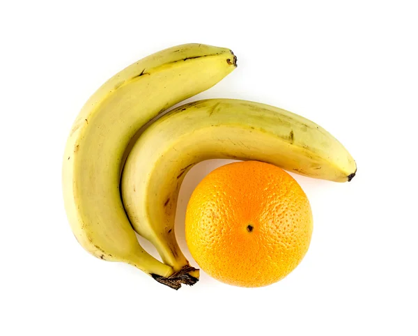 Bananen mit einer Orange — Stockfoto