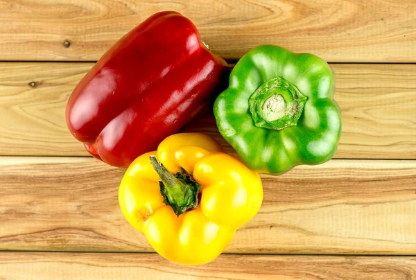 Ripe peppers on chopping board — Stock Photo, Image