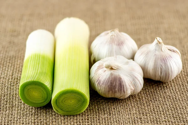 Puerro verde sano fresco y bulbos de ajo — Foto de Stock