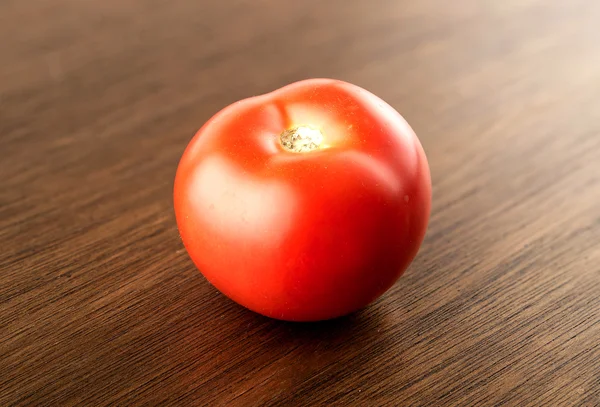 Gourmet harvested tomato on dark wood — Stock Photo, Image