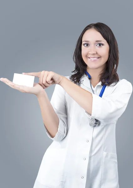 Medical Female Doctor Presenting and Showing White Card for Product or Text