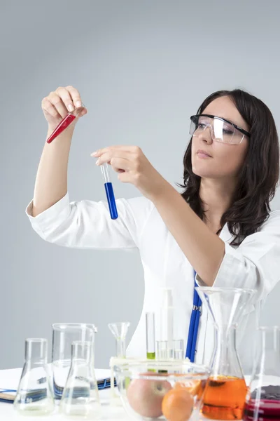 Medicine and Science Concepts. Caucasian Female Researcher Compares Substances in Two Separate Flasks