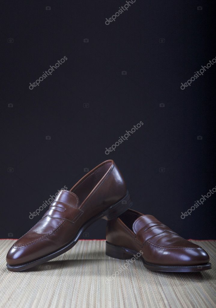 Mens Brown Penny Loafer Shoes Against Black Background Stock Photo by ...