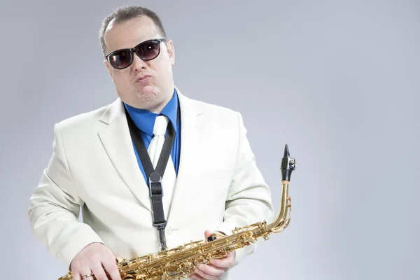 Expressive Funny Male Saxo Player in White Suit and Sunglasses