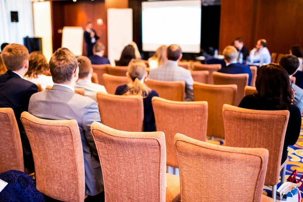 Professional Male Host  Speaking In Front of the Businesspeople in The Hall. Horizontal Image