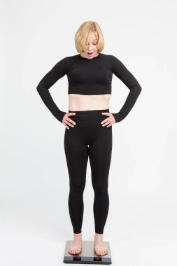 Kıdemli Kafkas Kadın 'ın kilosunu yer ölçme tartısıyla kontrol etmesine şaşırdım. Dikey Resim Kompozisyonu