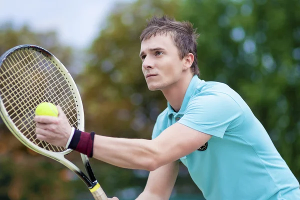 Sport and Tennis Concept: Handsome Caucasian Man With Tennis Raq