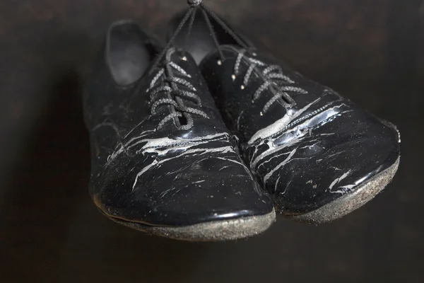 Closeup Shot of Pair of Worn-out Standard European Ballroom Dance Shoes. Against Black