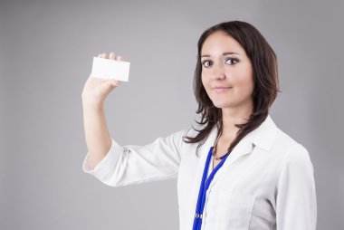 Young Medical Female Doctor Presenting and Showing White Card fo
