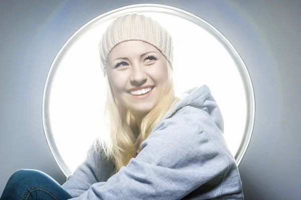 Portrait of Happy and Laughing Caucasian Blond Woman in Warm Hat