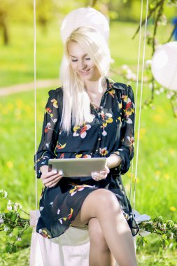 Modern Lifestyle Concept: Caucasian Blond Female Reading Ebook