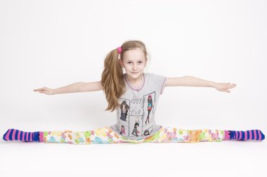 Happy and Cheerful Caucasuan Blond Girl Stretching and Doing the Splits