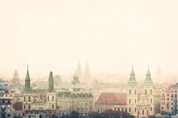 An European foggy townscape, rooftops, churches, vintage