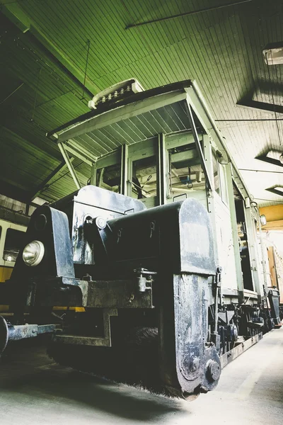 Old electric rail vehicles in a garage cleaning — Stok fotoğraf