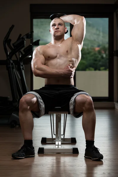 Joven culturista ejercicio tríceps en el gimnasio —  Fotos de Stock