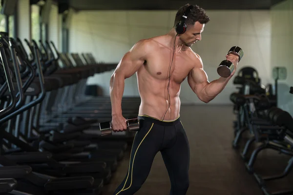 Ung Man gör övning för Biceps med hantlar — Stockfoto