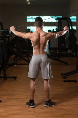 Bodybuilder Exercising Back On Cable Machine