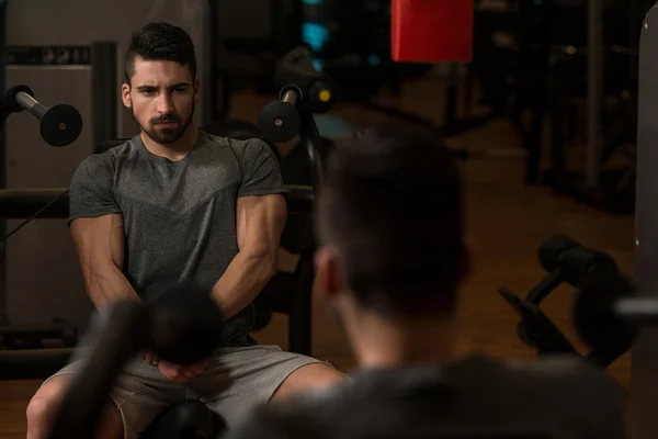 Culturista mostrando la sua muscoli e in posa in palestra — Foto Stock