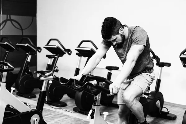 Muscular Man Doing Cycling In Modern Fitness Center — Stock Photo, Image