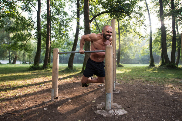 Young Sportsman Working Out In A Park