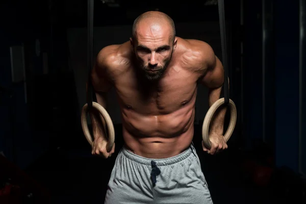 Muscular Man Holding Two Rings — Stock Photo, Image