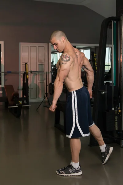 Muscular hombre flexión tríceps en el gimnasio — Foto de Stock