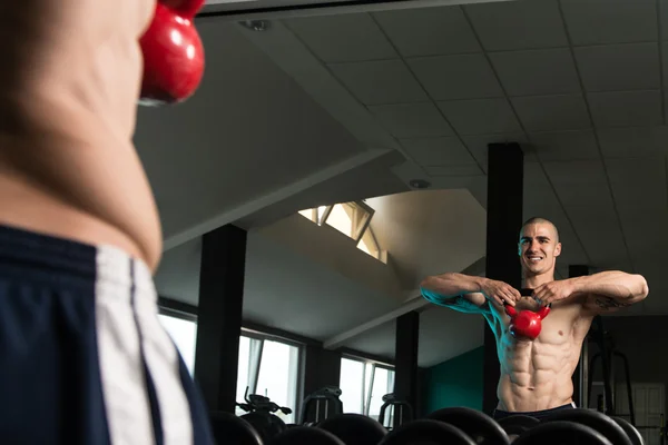 Kettle Bell Exercise In Front Of A Mirror