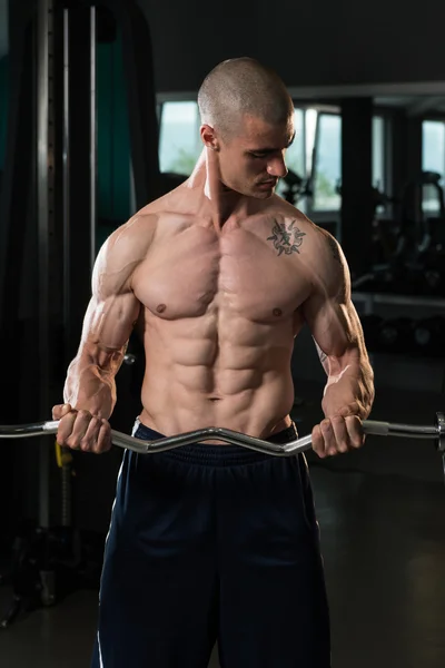 Bodybuilder Performing Biceps Curls With A Barbell — Stock Photo, Image