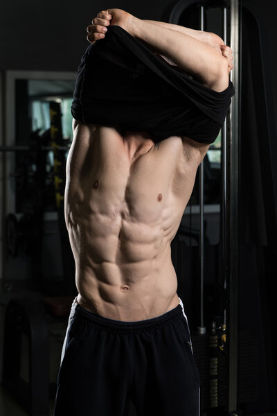 Bodybuilder Taking His Shirt Off After Training