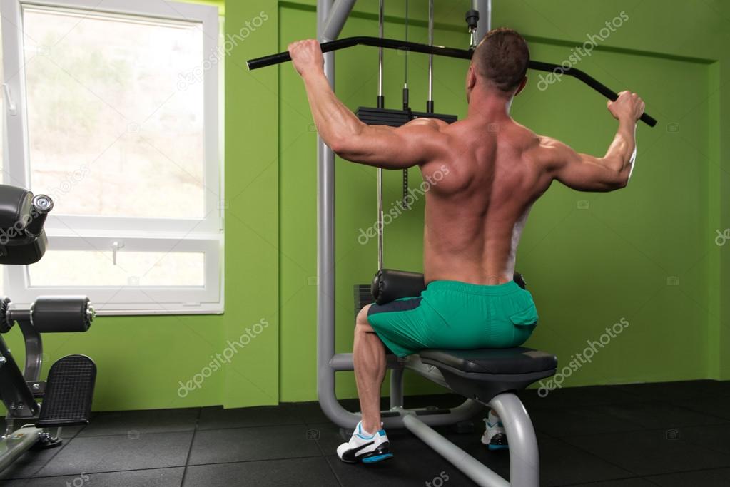 Muscular Man Doing Heavy Weight Exercise For Back