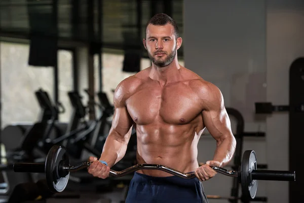 Bodybuilder Performing Biceps Curls With A Barbell — Stock Photo, Image